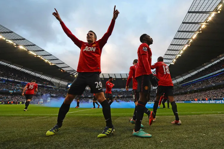 Wayne Rooney (R) is congratulated by Robin van Persie after scoring Manchester United’s opening goal at Etihad Stadium in the Manchester derby on Sunday, Dec. 9, 2012.