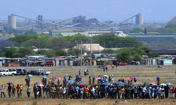 Hundreds of the 12,000 miners sacked by the world's largest platinum producer in South Africa are on their way to a hill where they will mourn a colleague who was killed in clashes with police in Bleskop on Oct. 6. (Alexander Joe/AFP/GettyImages)