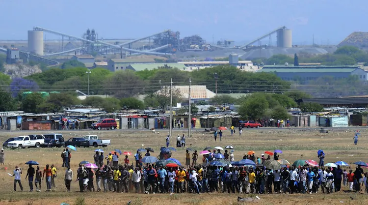 Hundreds of the 12,000 miners sacked by the world's largest platinum producer in South Africa are on their way to a hill where they will mourn a colleague who was killed in clashes with police in Bleskop on Oct. 6. (Alexander Joe/AFP/GettyImages)