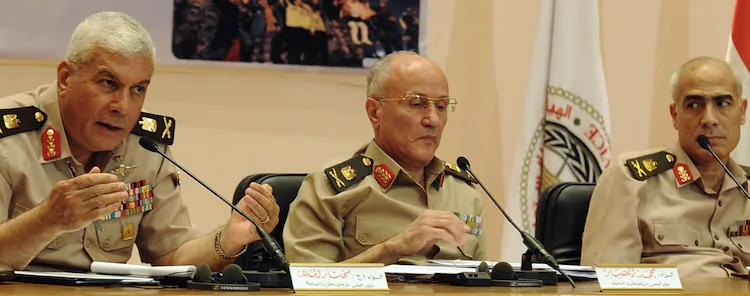 Egyptian General Mukhtar al-Mulla (L), Major General Mohammed al-Assar (C), and General Mamdouh Shahen (R), members of Supreme Council of the Armed Forces (SCAF), hold a press conference in Cairo on May 3, following clashes in Cairo on May 2. ( -/AFP/Getty Images)