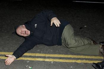 Photographer Tony Margiocchi lies in the road after being run over by Prince Harry's car. (Simon Gross/The Epoch Times) Photographer Tony Margiocchi lies in the road after being run over by Prince Harry's car. (Simon Gross/The Epoch Times)