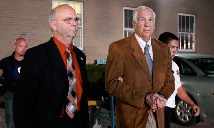 Former Penn State assistant football coach Jerry Sandusky leaves the Centre County Courthouse in handcuffs after a jury found him guilty in his sex abuse trial on June 22, 2012, in Bellefonte, Penn. The jury found Sandusky guilty on 45 of 48 counts in the sexual abuse trial of the former Penn State assistant football coach, who was charged with sexual abuse of 10 boys over a 15-year period. (Rob Carr/Getty Images)