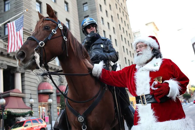 Salvation Army bell ringer Dave Seiler (R) pets a San Francisco Police horse on Dec. 13 in San Francisco. With less than two weeks before Christmas, San Franciscans are getting into the holiday spirit. (Justin Sullivan/Getty Images)