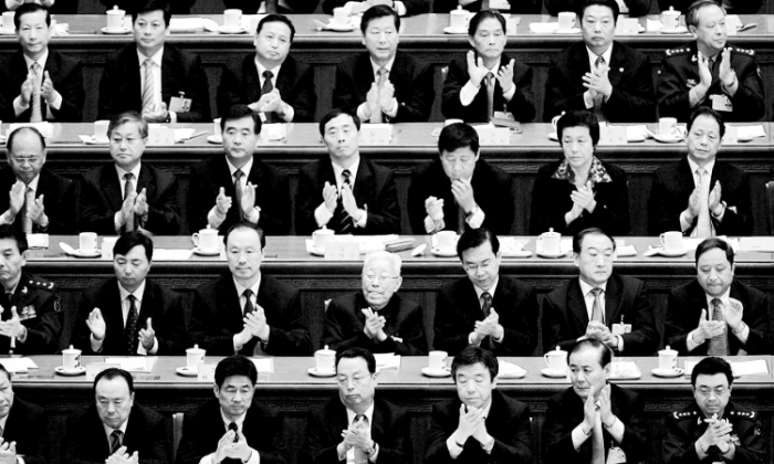Chinese delegates applaud the result of a vote during the Chinese Communist Party Congress at the Great Hall of the People on October 21, 2007, in Beijing. (Andrew Wong/Getty Images)