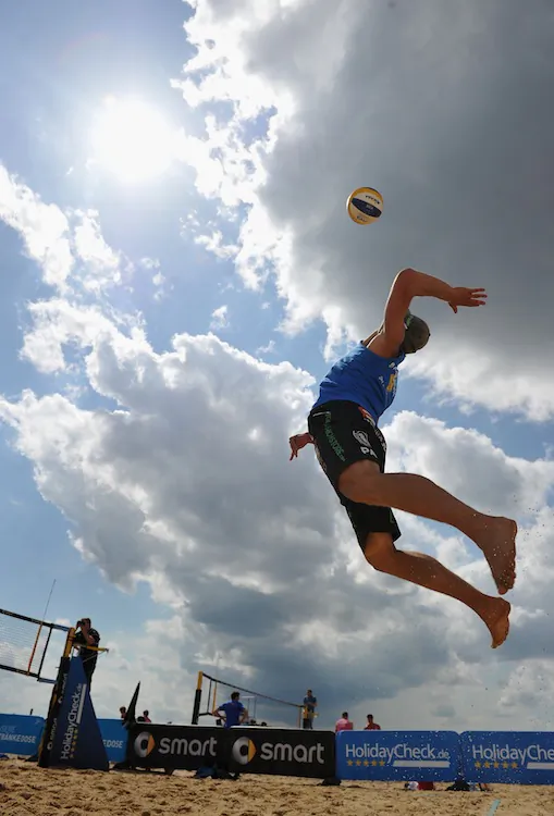 Paul Becker jump serves in a Smart Beach Tour 2012 beach volleyball event on June 8 in Hamburg, Germany. (Stuart Franklin/Bongarts/Getty Images)