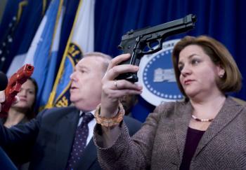 Council Speaker Christine Quinn (C) holds up a toy gun that looks too much like a real gun. (William Alatriste/New York City Council)