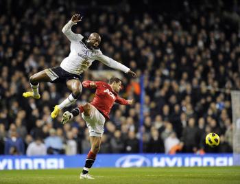 Tottenham's William Gallas (L) and Manchester United's Javier Hernandez vie for the ball in a hotly-disputed match on Sunday. (Glyn Kirk/AFP/Getty Images) Tottenham's William Gallas (L) and Manchester United's Javier Hernandez vie for the ball in a hotly-disputed match on Sunday. (Glyn Kirk/AFP/Getty Images)