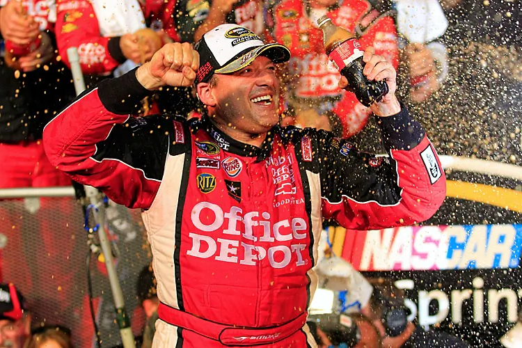 Tony Stewart celebrates in Victory Lane after winning the NASCAR Sprint Cup Ford 400 and the 2011 Championship at Homestead-Miami Speedway. (Chris Trotman/Getty Images for NASCAR)