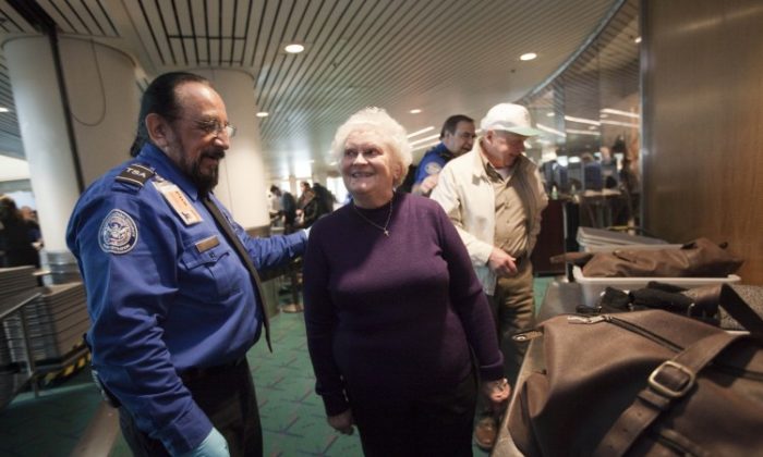 In this file photo, TSA officer Stephen Candia (L) explains new rules to Evelyn Schulze, 76, at Portland International Airport (PDX) on March 19. The TSA has modified screening procedures for passengers 75 and older. (Natalie Behring/Getty Images)