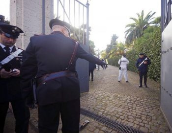 Italian Carabinieri work in front of the main gate of the Swiss embassy in Rome on Wednesday. A bomb exploded there earlier in the day, injuring one, followed by another bomb explosion at the Chilean embassy, which also injured one person, according to reports by ANSA news agency. (Filippo Monteforte/AFP/Getty Images))
