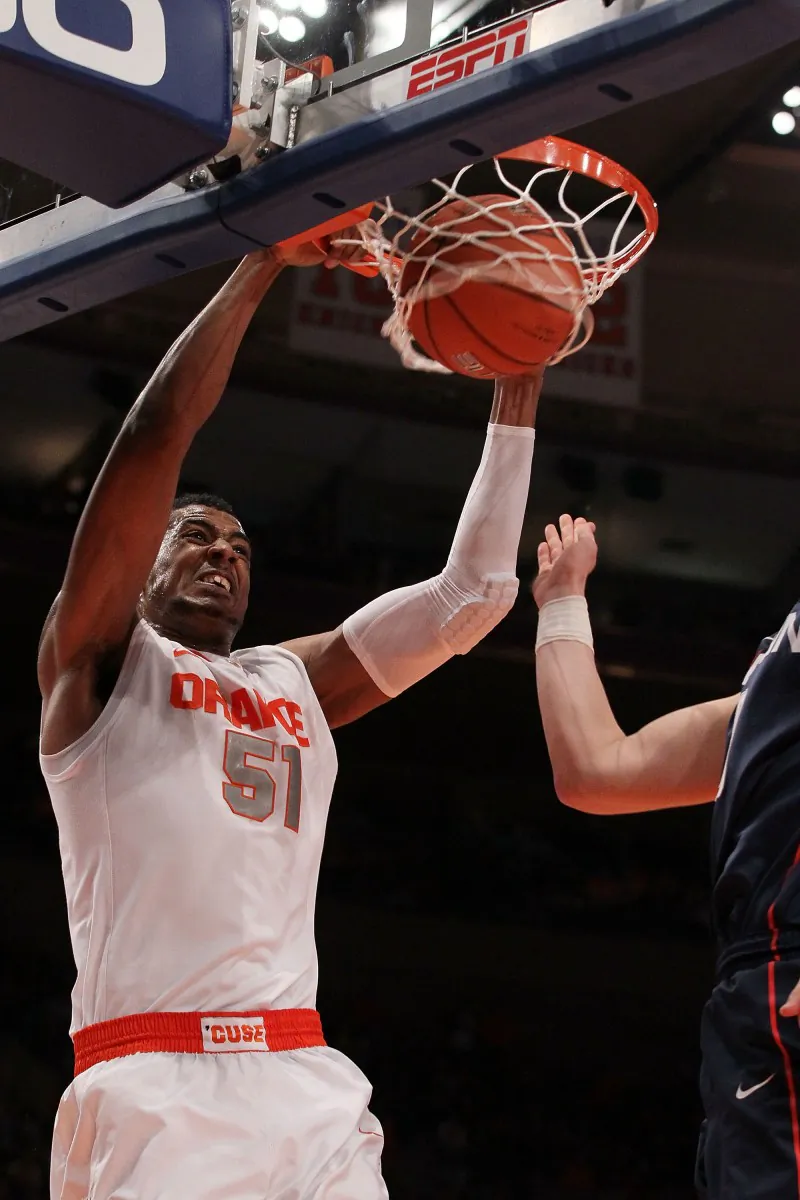 Syracuse center Fab Melo slams home two of his seven points. He also added six rebounds. (Jim McIsaac/Getty Images)