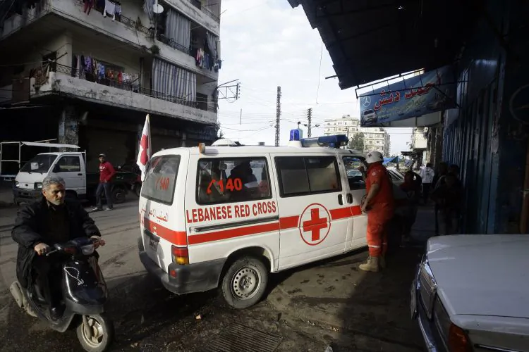 Red Cross volunteers arrive to evacuate wounded people in the Sunni neighbourhood of Bab al-Tabbaneh, on Feb. 11,  2012. The Red Cross on Sunday said that it still cannot get into the Homs neighborhood of Baba Amr, which has been under attack by the Syrian army. (Joseph Eid/AFP/Getty Images)