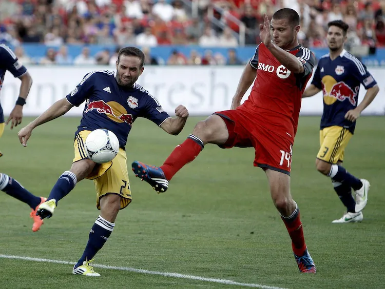 Toronto FC’s Danny Koevermans (R) battles with New York’s Brandon Barklage at BMO Field in Saturday’s MLS action. (Abelimages/Getty Images)