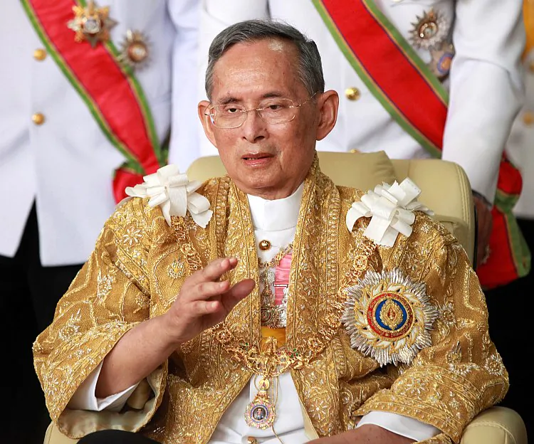 Thailand's King Bhumibol Adulyadej waves from his wheelchair in Bangkok on his 84th birthday Dec. 5, 2011. (Pairoj/AFP/Getty Images)