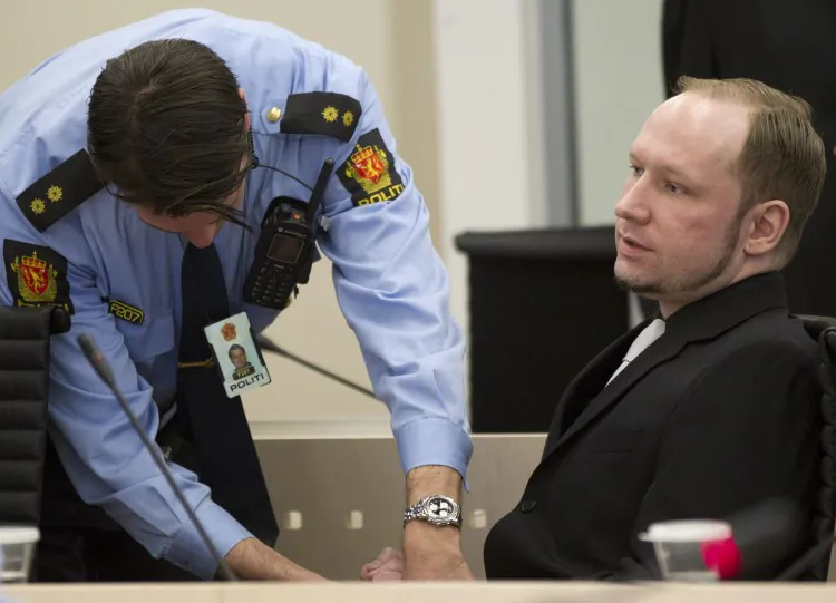 Right-wing extremist Anders Behring Breivik's handcuffs are removed in an Oslo courtroom on April 20. On day five of his trail for mass murder, Breivik gave a detailed account of his shooting rampage on Utoeya Island on July 22, 2011. (Daniel Sannum Lauten/AFP/Getty Images)