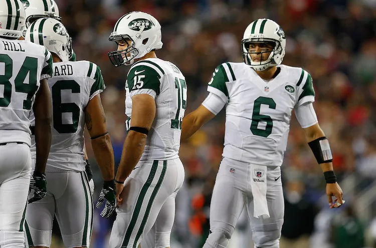Using Mark Sanchez (R) and Tim Tebow (C) this year clearly has not benefited the Jets' punch-less offense. (Jim Rogash/Getty Images)