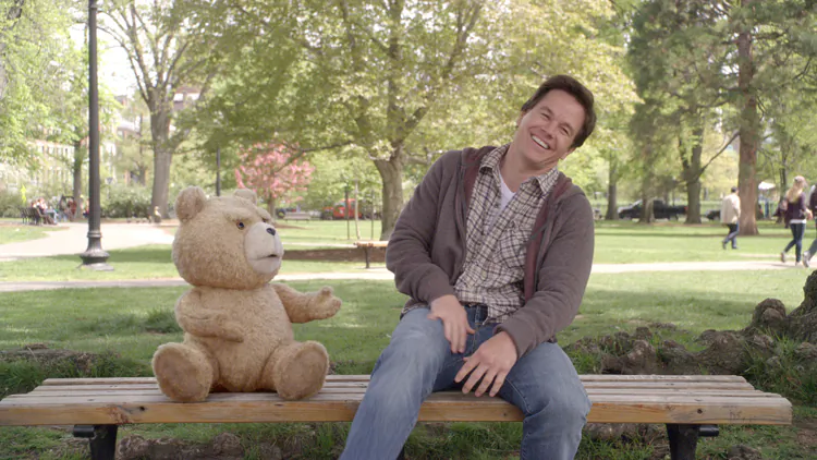 Mark Wahlberg as John with his best friend “Ted,” voiced by Seth MacFarlane, in the CG-animated comedy “Ted,” a film about the lifelong friendship between a man and his teddy bear that came to life. (Courtesy of Universal Pictures)