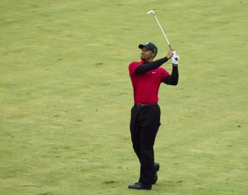 Tiger Woods hitting his shot to the ninth green on Sunday. He parred the hole and finished the first nine holes at even par 36. (Dan Sanchez/The Epoch Times) Tiger Woods hitting his shot to the ninth green on Sunday. He parred the hole and finished the first nine holes at even par 36. (Dan Sanchez/The Epoch Times)