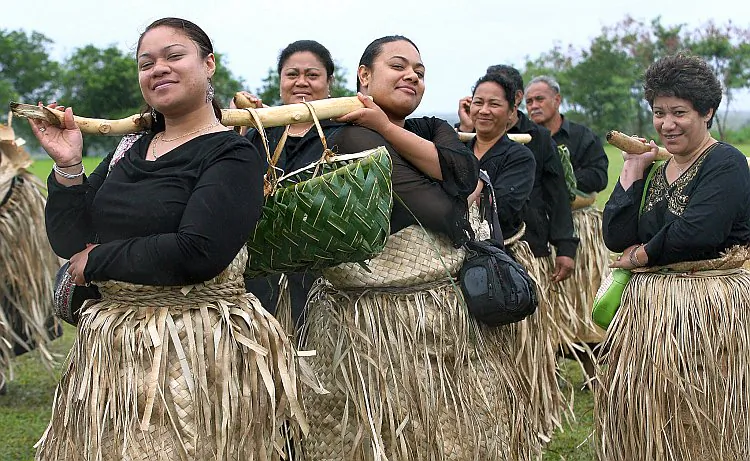 Women in traditional dress deliver a specially prepared lunch to the royal household in Nukualofa, Tonga, on Sept. 20, 2006. (Greg Wood/AFP/Getty Images)