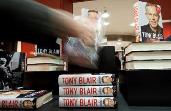 A man takes a copy of former British Prime Minister Tony Blair's memoirs, 'A Journey' as it goes on sale at Waterstone's book store in London, on September 1, 2010. (Leon Neal/AFP/Getty Images)