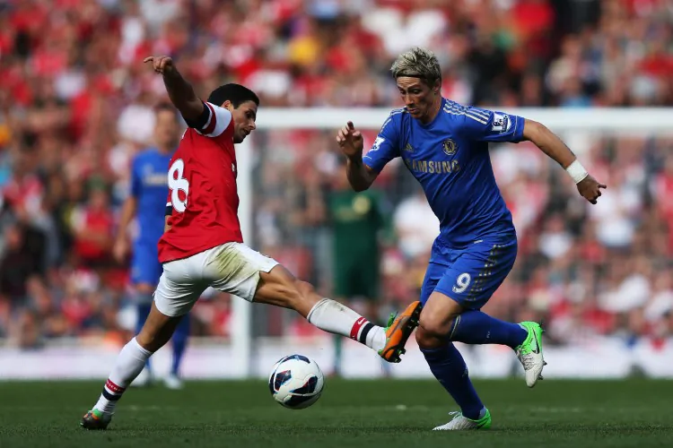 Chelsea’s Juan Mata applauds his team’s performance and their supporters at Emirates Stadium on September 29, 2012 in London, England. The Spanish midfielder scored his team’s second goal. (Richard Heathcote/Getty Images)