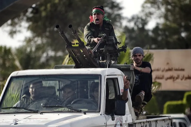 Libyan government forces arrive at Tripoli International Airport to join in negotiations with the al-Awfea Brigade that overran the airport a few hours earlier on June 4. (GianLuigi Guercia/AFP/Getty Images)