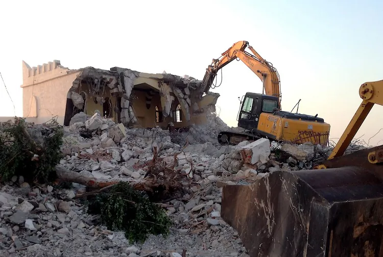 Libyan Islamist hardliners use a bulldozer to raze the mausoleum of Al-Shaab Al-Dahman near the centre of Tripoli on Aug 25. Islamist hardliners bulldozed part of the revered mausoleum in Tripoli in the second such attack in Libya in two day. (Mahmud Turkia/AFP/GettyImages)