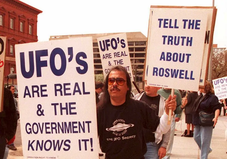 A group of protestors march in front of the General Accounting Office (GAO) 29 March to raise awarness about an examination being conducted by the GAO for documents about a weather balloon crash at Roswell, N.M. in 1947. (Joshua Roberts/AFP/Getty Images)