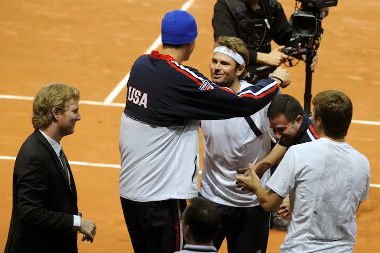 John Isner congratulates Mardy Fish (C) after the U.S.'s first round victory over Switzerland in the 2012 Davis Cup. (Sebastien Feval/AFP/Getty Images)
