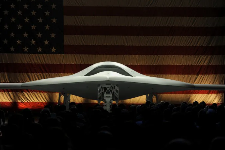 X-47B UCAS workers on runway. The drone will be the first of its kind to be able to land on an aircraft carrier without a pilot. (Courtesy of Northrop Grumman)