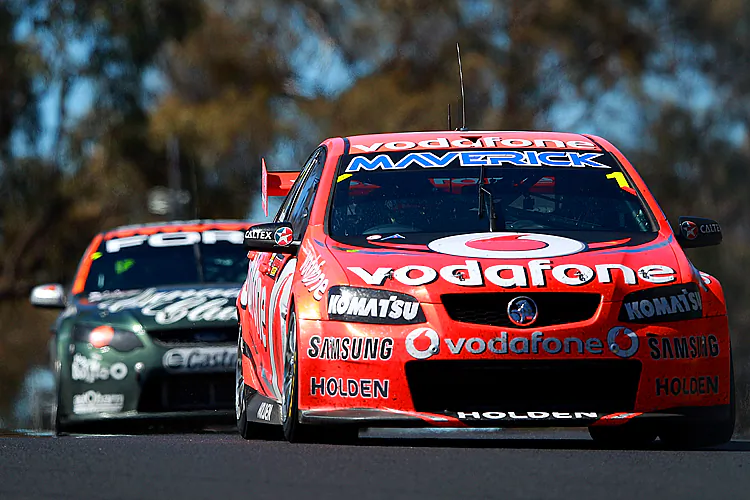Paul Dumbrell and Jamie Whincup hold aloft the Peter Brock Trophy after winning the Bathurst 1000. (Matt Blyth/Getty Images)
