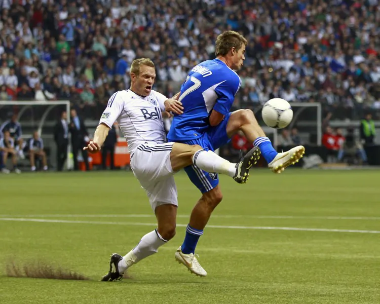 Vancouver’s Jay DeMerit (L) challenges Montreal’s Justin Braun for the ball in MLS First Kick action Saturday at B.C. Place Stadium. (Jeff Vinnick/Getty Images)