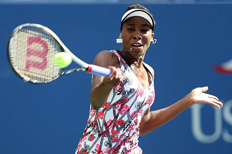 Venus Williams returns a forehand to Bethanie Mattek-Sands during their women's singles first round match on Day Two of the 2012 US Open. (Elsa/Getty Images)