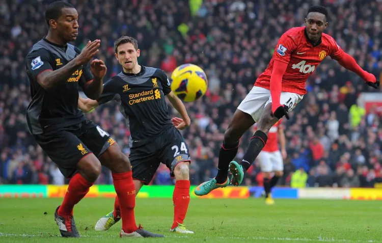 Manchester United striker Danny Welbeck shoots past two Liverpool defenders in his team’s victory at Old Trafford in Manchester on Sunday, Jan. 13, 2013. (Andrew Yates/AFP/Getty Images)