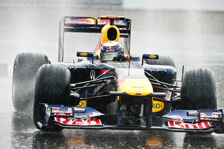 Sebastian Vettel crashed in the rain while leading the 2011 Canadian Grand Prix, partly the result of pressure from McLaren’s Jenson Button. Could the Red Bull driver have similar troubles in Sao Paulo, as he tries to win his third WDC? (Rogerio Barbosa/AFP/Getty Images)