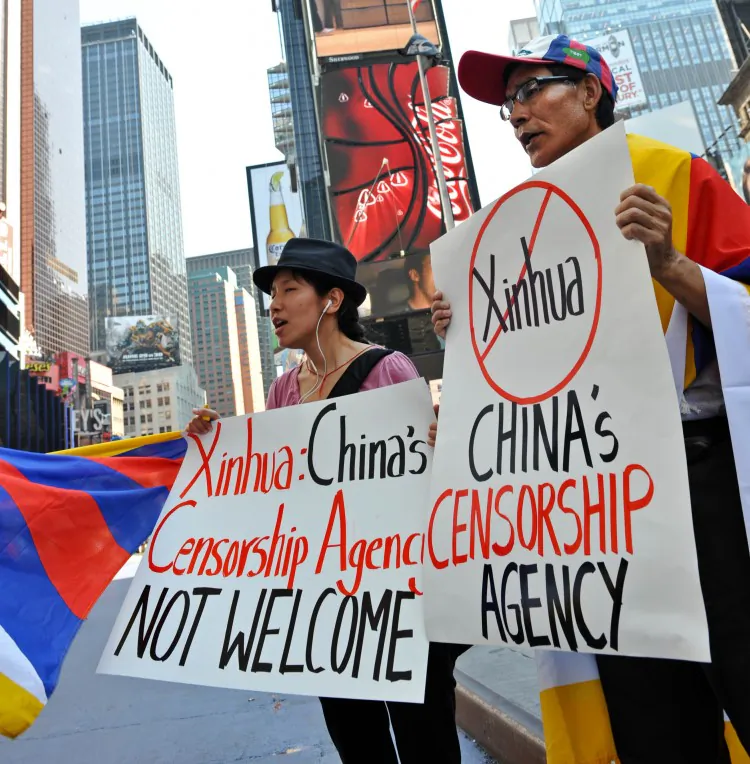 Students for a Free Tibet protest below a new electronic billboard leased by Xinhua (2nd from top), the Chinese regime's propaganda agency, in 2011 in New York's Times Square. Recently a proofreader with the regime's Central Propaganda Department published a list of propaganda and censorship guidelines online. (Stan Honda/AFP/Getty Images)