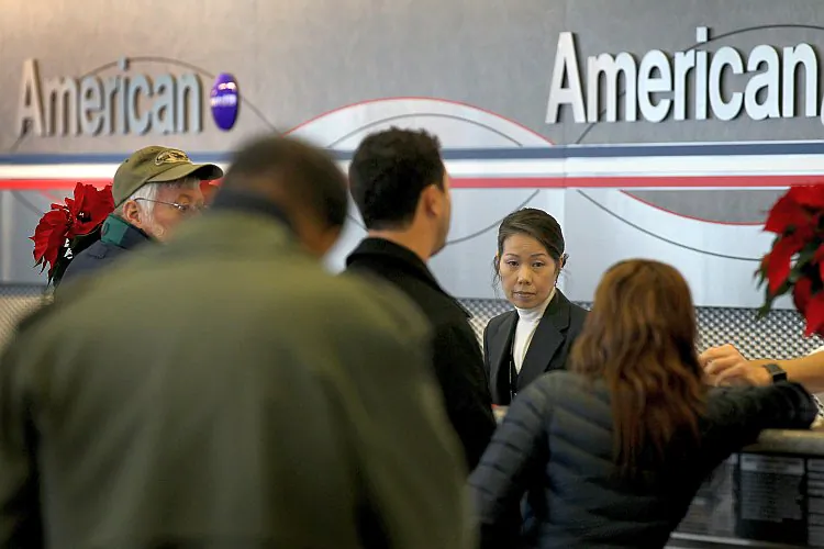 American Airlines passengers check in for flights at O'Hare Airport in Chicago, Ill., Nov. 29. AMR, the parent of American Airlines, filed for bankruptcy protection on Tuesday. The company's stock plunged about 80 percent on the news. (Scott Olson/Getty Images)