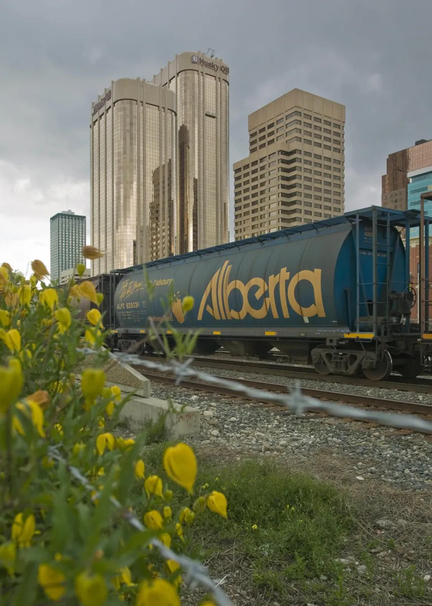 A freight train passes through Calgary’s city centre in front of the Husky Oil building. (David Boily/AFP/Getty Images)
