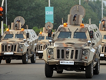 Mumbai policemen ride in armored vehicles during a parade to commemorate the second anniversary of the November 2008 terror attacks in Mumbai on Nov. 26. (Punit Paranjpe/AFP/Getty Images)