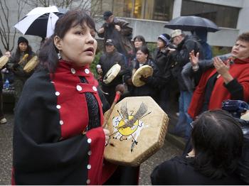Natives drum and chant outside court in New Westminster, Canada, on the first day of the grisly murder trial of pig farmer Robert Pickton in January 2007. (Jeff Vinnick/Getty Images)