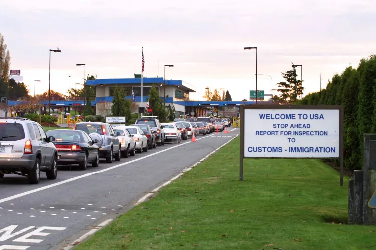 File photo shows vehicles waiting to enter the U. S. at the border crossing between Blaine, Washington, and White Rock, B.C., in White Rock. Canada and the U.S. have launched a pilot project for U.S.-bound trucks to be inspected by U.S. officials in Canada to avoid delays at the border. (Jeff Vinnick/Getty Images)