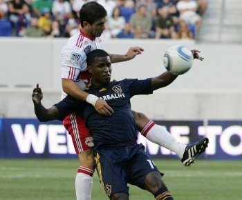 Carlos Mendez (L) of the New York Red Bulls climbs over L.A. Galaxy's Edson Buddle at Red Bull Arena on Saturday. (Andy Marlin/Getty Images)
