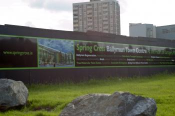 REGENERATION: The old Ballymun flats in north Dublin cast a shadow over a poster depicting a new vision for the region. (Martin Murphy/The Epoch Times)