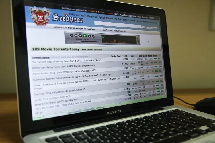 Downloadable torrents for pirated movies are listed on the Speedpeer website on Nov. 23. (Benjamin Chasteen/The Epoch Times)