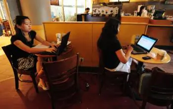 Women use their laptop computers at a wireless cafe in Beijing.  (Frederic J. Brown/AFP/Getty Images)