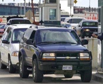 Vehicles stop at a border checkpoint in Detroit after crossing the Ambassador Bridge, which connects Detroit, Mich., and Windsor, Ontario. With layers of new regulations and inspections often leading to long wait times, the Canadian Chamber of Commerce is calling for improved border efficiency between Canada and the United States. (Jeff Kowalsky/AFP/Getty Images)
