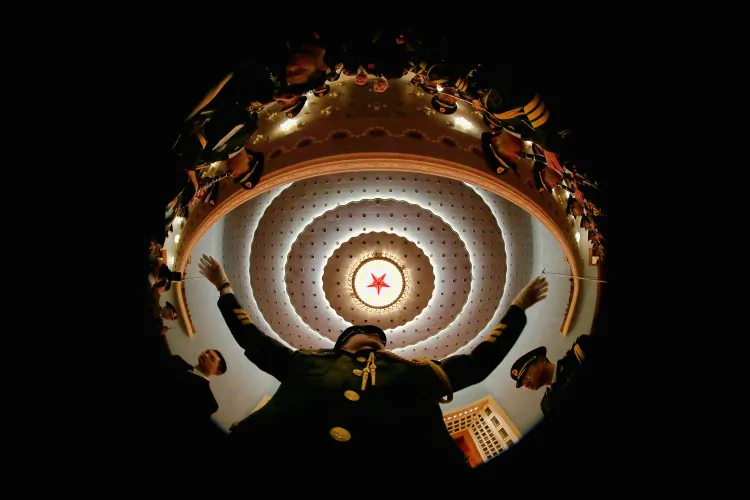 A conductor of a military band performs during a rehearsal before the opening session of the Chinese People's Political Consultative Conference in Beijing's Great Hall of the People on March 3. The Chinese regime's military budget has shot up in recent years as the Party buys the loyalty of PLA leaders. (Feng Li/Getty Images)