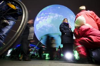 People walk by the gigantic earth globe on the town square in Copenhagen on December 6, 2009, on the eve of the opening of the United Nations Climate Conference 2009. (Mikkel Moeller Joergensen/AFP/Getty Images)