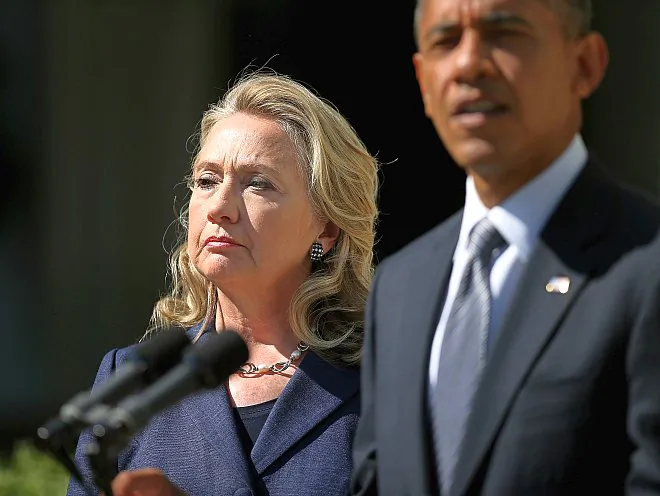 U.S. Secretary of State Hilary Clinton stands with President Barack Obama on Sept. 12, 2012, as he speaks about the death of four Americans in an attack on the U.S. Embassy in Benghazi, Libya. Clinton spoke about her role in ensuring the embassy's security in a CNN interview on Oct. 16. (Chip Somodevilla/Getty Images)