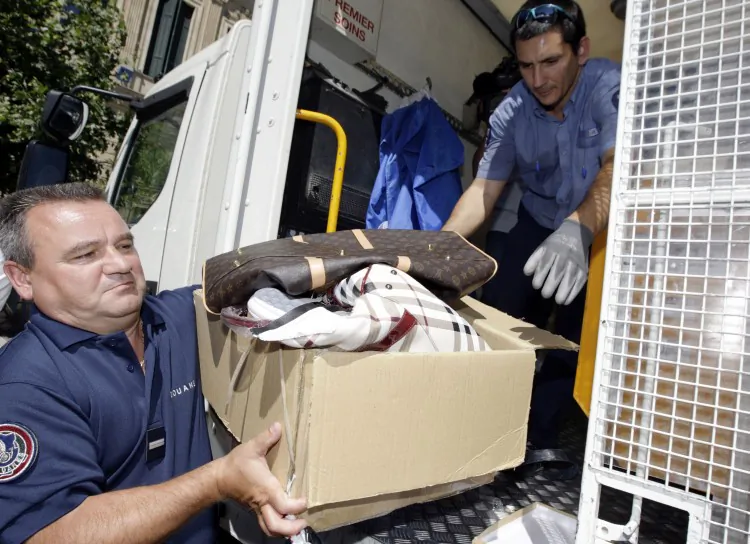 French customs officials prepare to destroy contraband goods during an anti-counterfeiting media stunt in Cannes on July 12. Purchasing counterfeit leads to changes in a consumer’s mindset, and could send that person down a path of further dishonesty, says Dan Ariely, professor of behavioural economics at Duke University. (Jean-Christophe Magnenet/AFP/GettyImages)